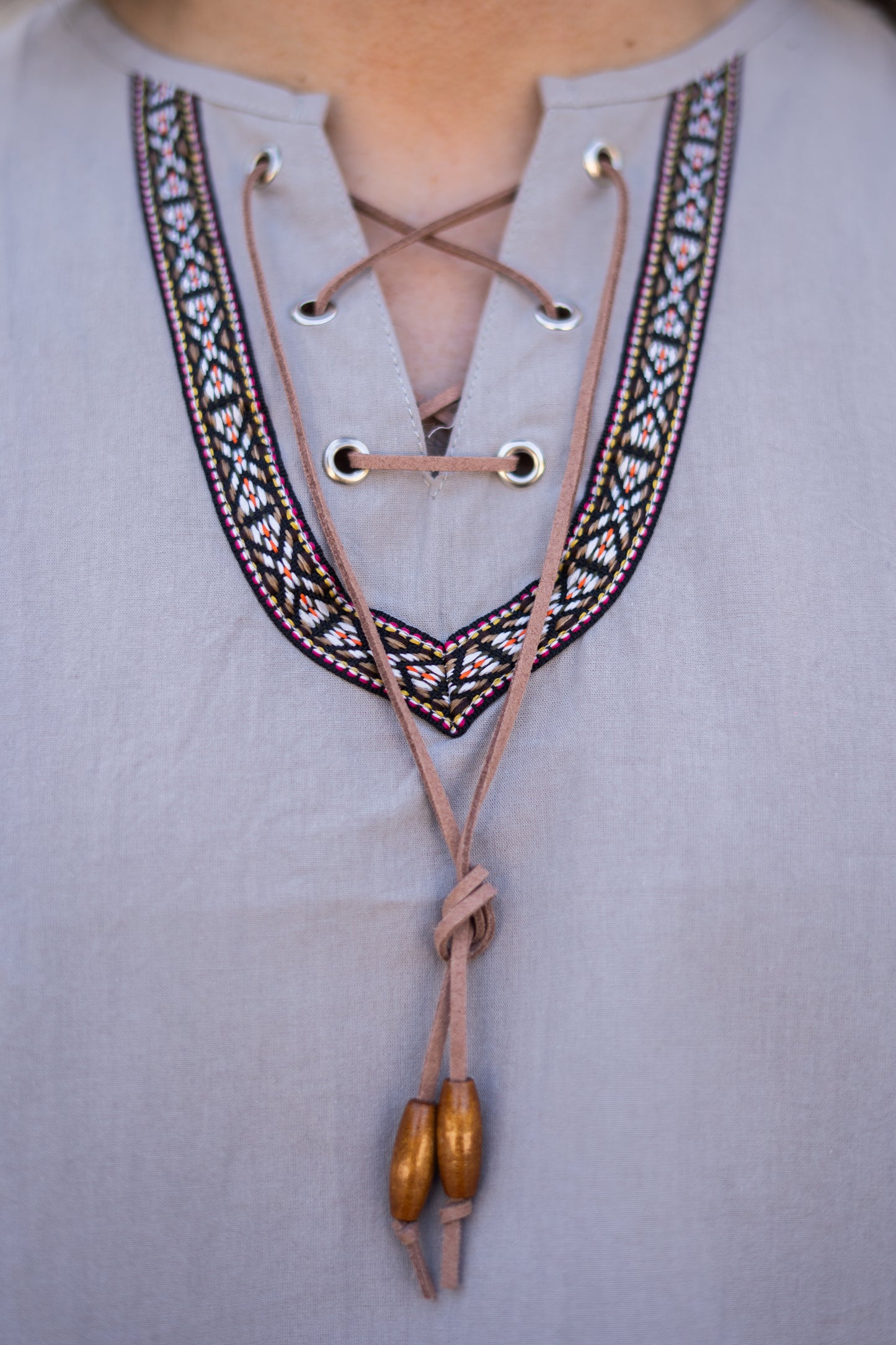 Détail du col brodé boho avec cordon ton sur ton et perles